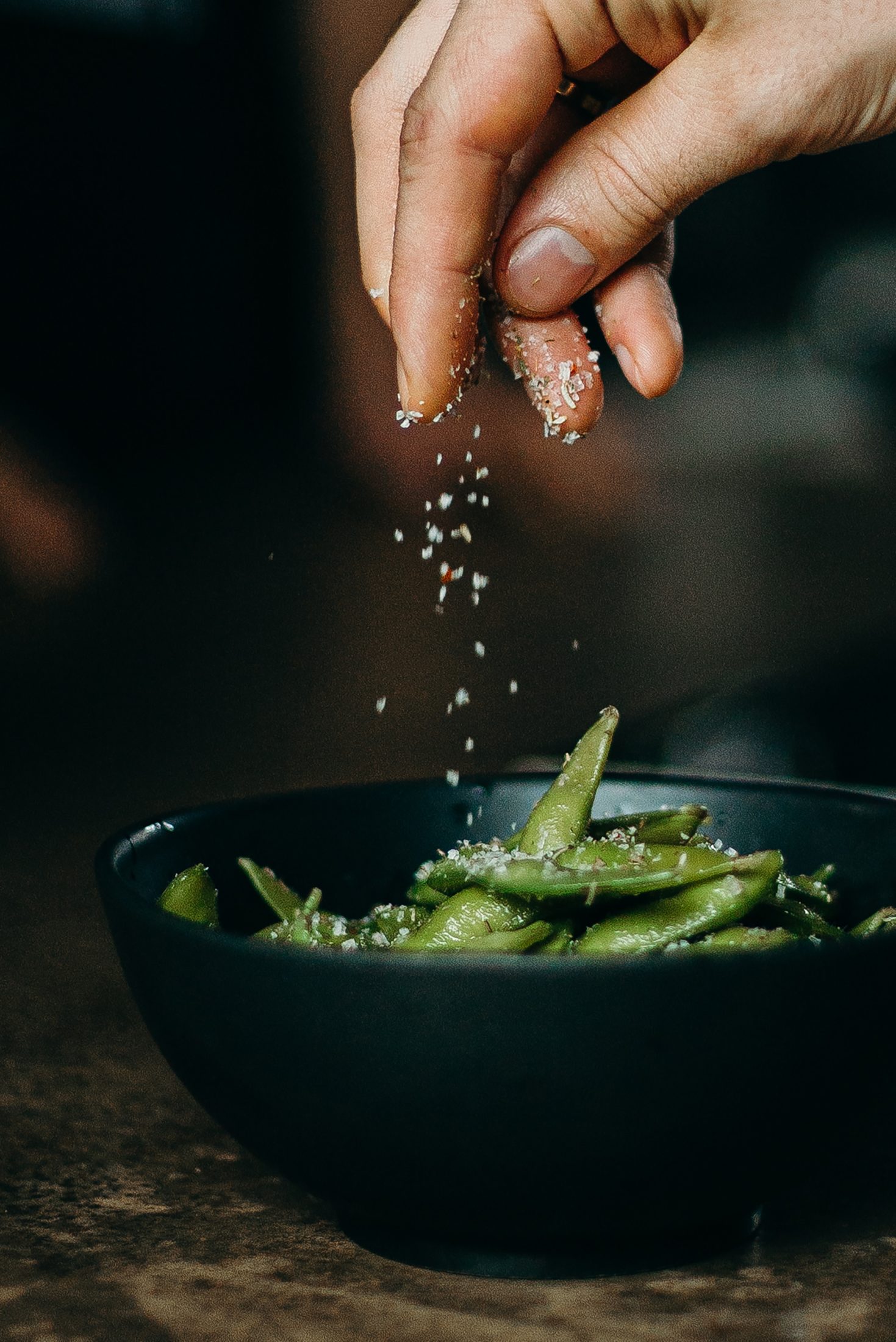 Chef seasoning a dish